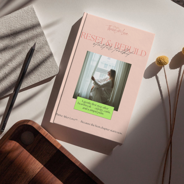 Thrive After Love ‘Reset & Rebuild’ guidebook on a table, offering support and a gentle plan for women healing after heartbreak or divorce.